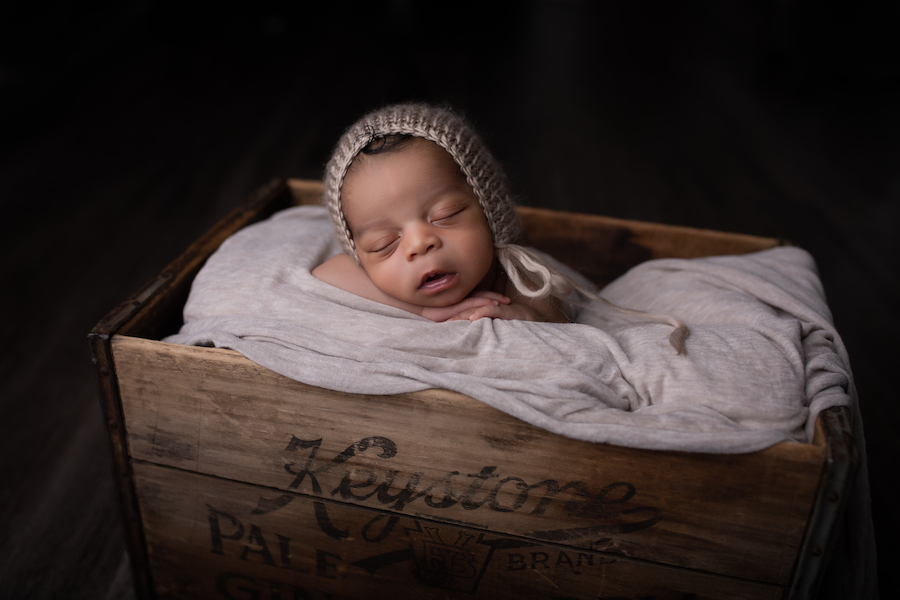 Baby boy in wooden crate