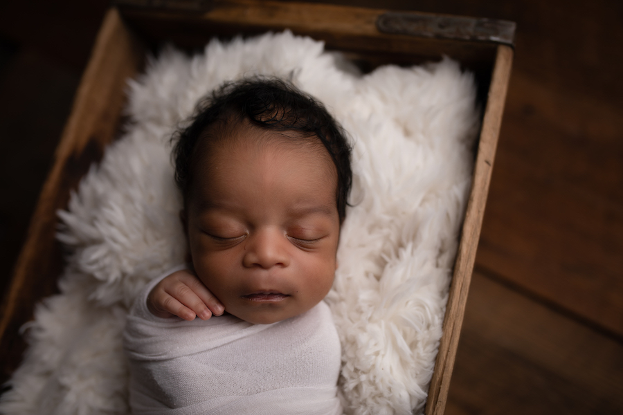 Newborn on fur blanket