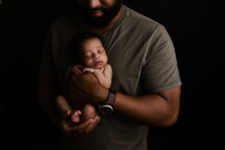 Dad holding baby against chest