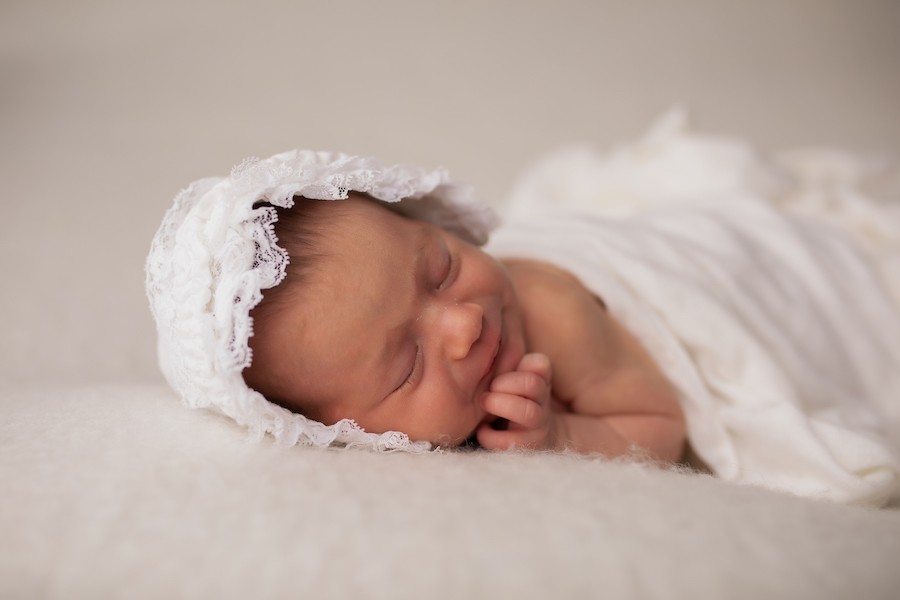 Newborn girl in bonnet