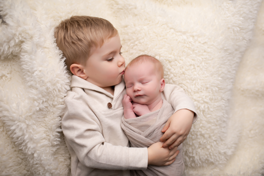 Big brother holding baby