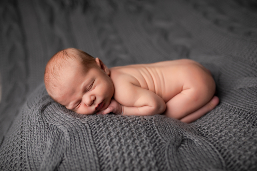 Posed newborn grey blanket