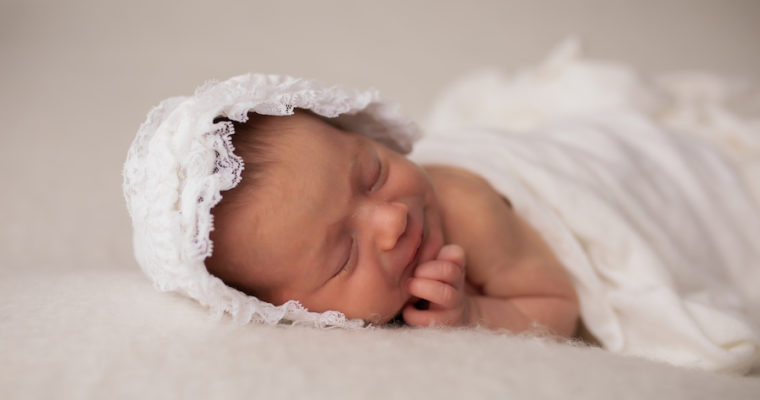 Newborn girl in bonnet
